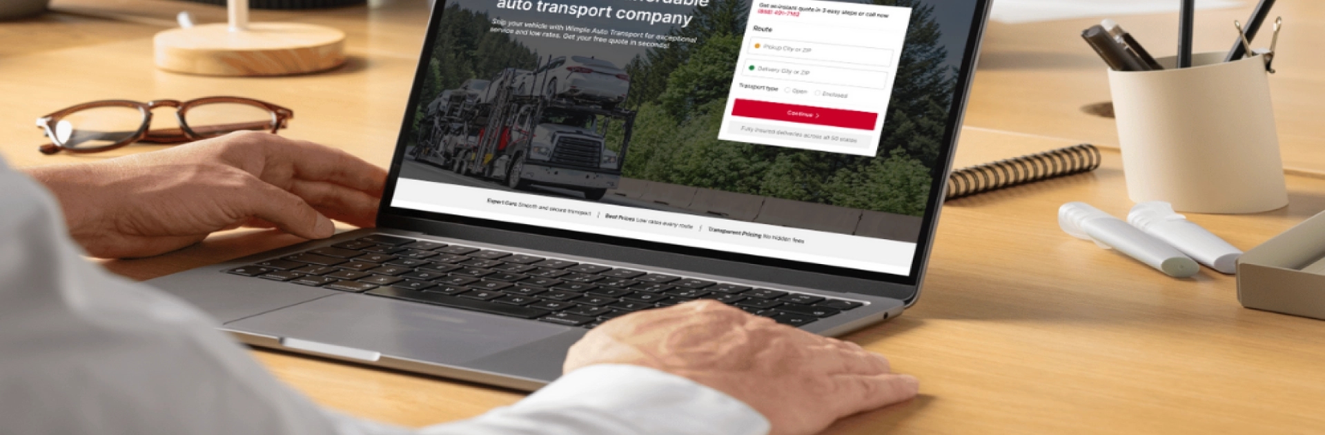 person using a laptop to get a free car shipping quote online