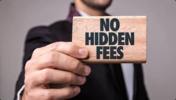 Hand holds wooden sign that reads no hidden fees