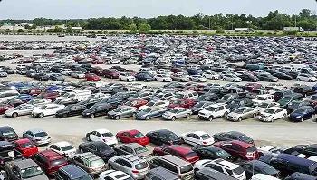 Auto auction vehicle lot Wide view of a crowded auto auction lot packed with parked vehicles