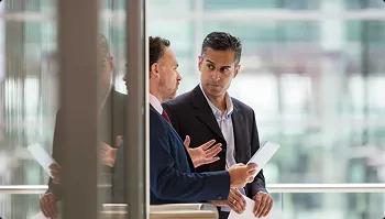 Transport partnership solutions Two business professionals discussing transport logistics in a modern office