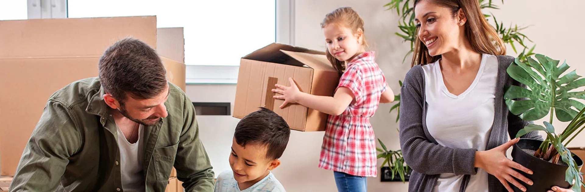 Car relocation services hero family moving boxes at home representing car relocation services