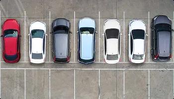 Vehicles parked for car shipping pickup top down view of parked vehicles in marked spaces ready for car shipping pickup