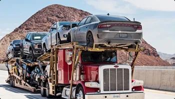 Open carrier car shipping on highway open car carrier semi hauling multiple vehicles on a desert highway