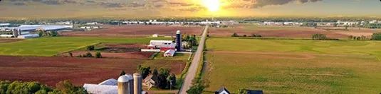 Rural areas country road through farmland showing rural pickup and delivery