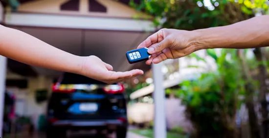 Door to door car key handover person receiving door to door car delivery key in driveaway