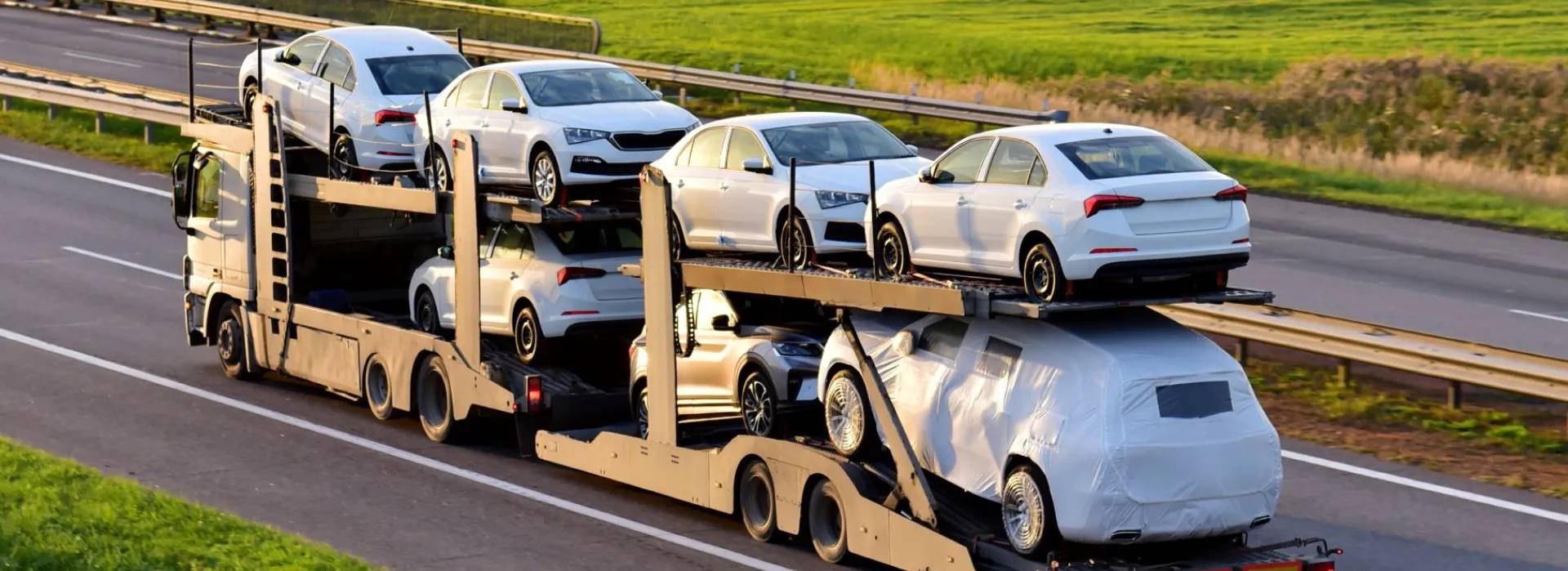 Open carrier transporting multiple vehicles open car carrier transporting multiple vehicles on a highway for auto transport