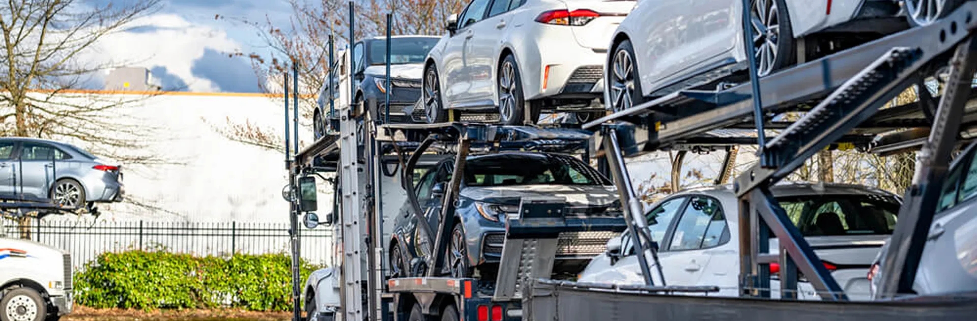 Military car shipping and PCS auto transport open car carrier loaded with vehicles representing military car shipping and pcs auto transport