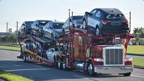 Open car carrier on road open car carrier hauling multiple vehicles on a suburban road