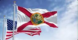 Florida car shipping routes florida state flag and us flag waving on poles under a blue sky