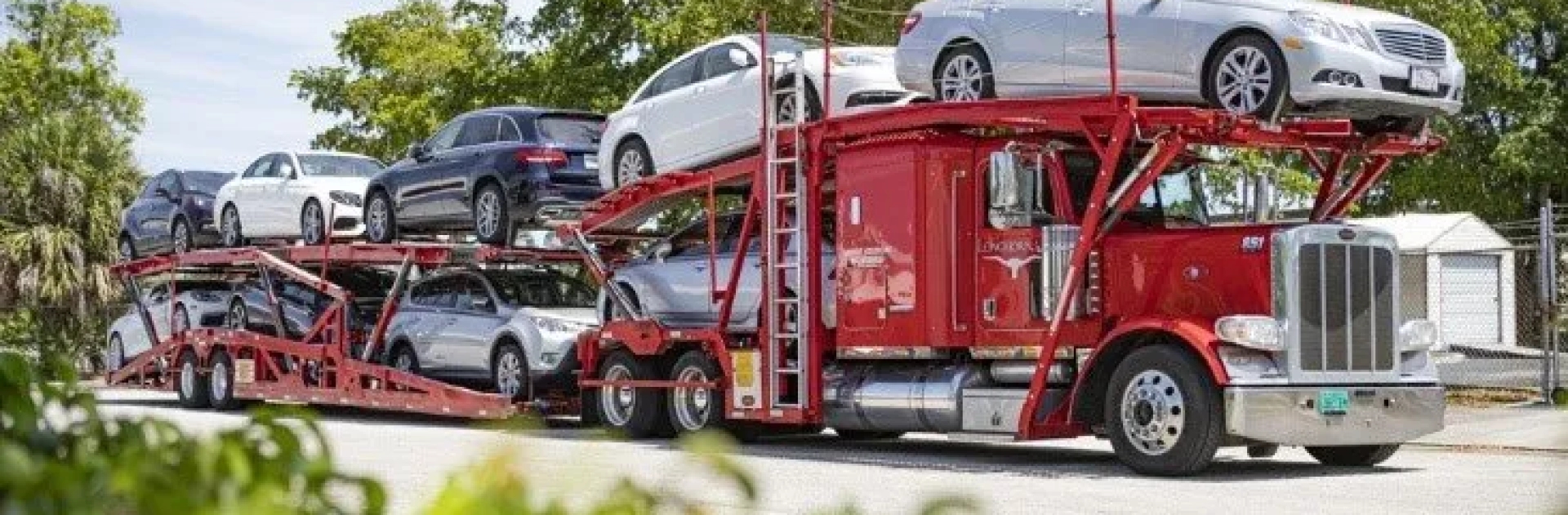 Car reseller auto transport services red multi car hauler transporting dealership vehicles for reseller auto transport