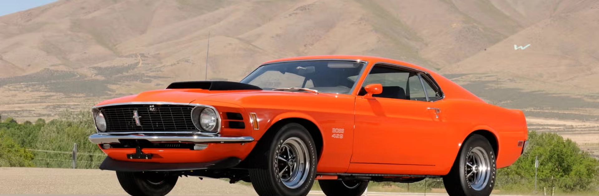 Classic car shipping enclosed and open options orange classic muscle car on open road representing classic car shipping