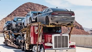 Open carrier car shipping on highway open car carrier semi hauling multiple vehicles on a desert highway