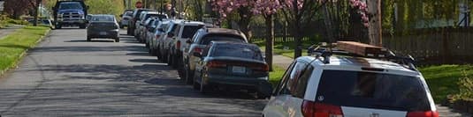 Residential street pickup and delivery row of parked cars along a residential street ready for pickup and delivery