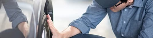 Vehicle condition technician inspecting a car door for non running or oversized vehicle notes