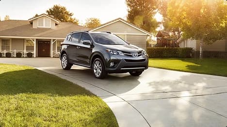 Residential driveway car delivery suv parked in front of a suburban home after door to door car delivery