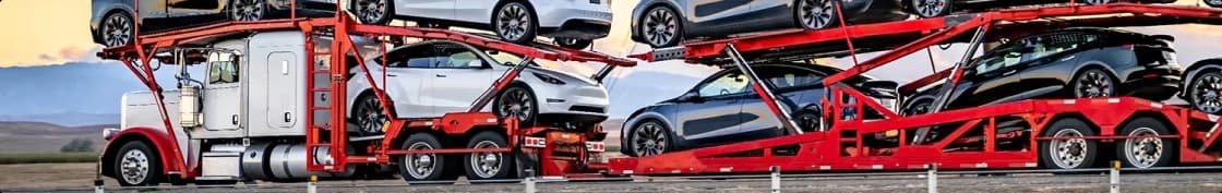 Open car hauler red trailer red open car hauler transporting electric vehicles across highway
