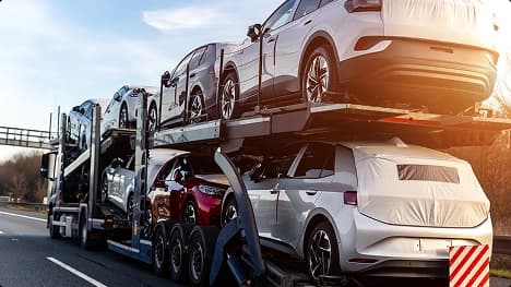 Expedited auto transport loaded cars expedited auto transport truck hauling multiple new vehicles on highway