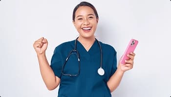 Healthcare Worker Car Shipping Support Smiling healthcare worker holding a phone, celebrating a discounted car shipping quote