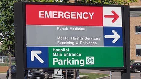 Hospital Directions And Parking Hospital sign showing directions to Emergency, Rehab Medicine, Mental Health Services, and parking