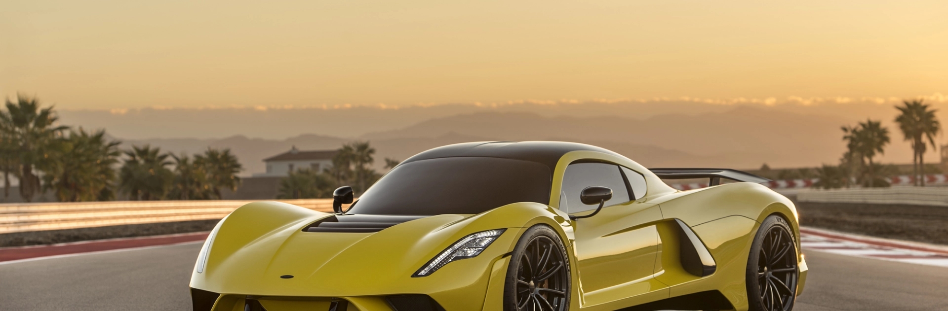 Luxury and exotic car shipping services yellow exotic sports car front quarter on track background representing luxury and exotic car shipping service