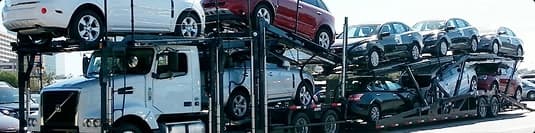 Multi level open car carrier on road open car carrier truck loaded with multiple vehicles on highway