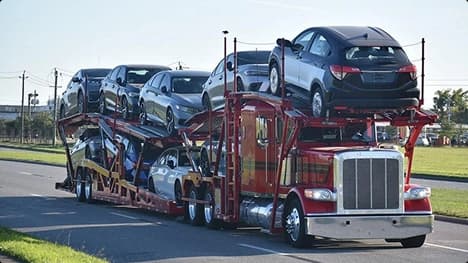 Open car carrier on road open car carrier hauling multiple vehicles on a suburban road
