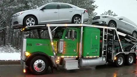 Snowbird car shipping winter ready open carrier green open car carrier hauling sedans in snowy weather showing snowbird car shipping and winter ready transports
