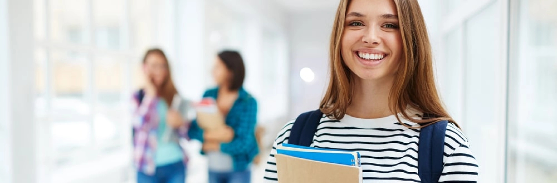 Student car shipping services smiling college student with backpack holding notebooks
